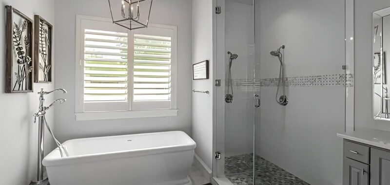 Monochromatic Bathroom With Freestanding Tub Next to Shower
