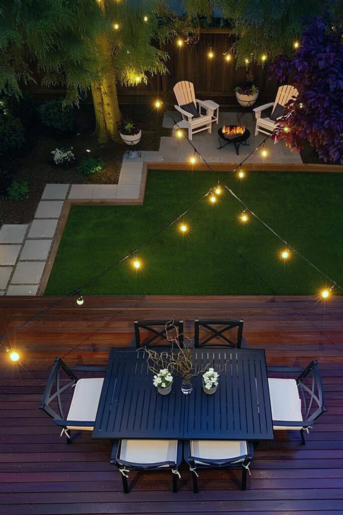 Chic Backyard Design With Dark Dining Set,  Firepit, And String Lights