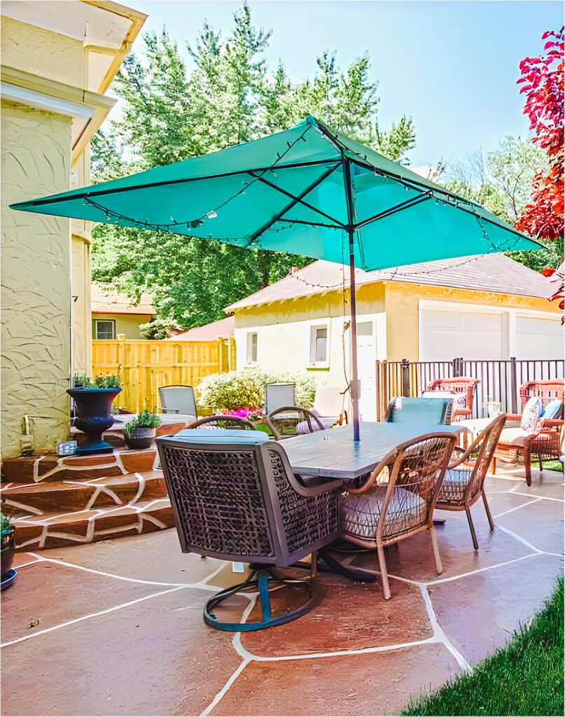 Chic Concrete Backyard with Paver Panache and Teal Umbrella