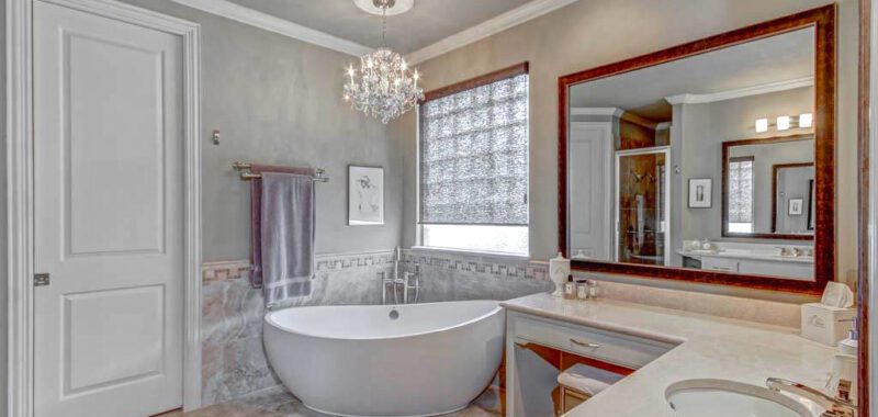 Master Bathroom with Crystal Chandelier and Modern Tub