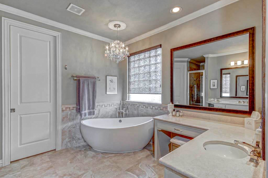Master Bathroom with Crystal Chandelier and Modern Tub
