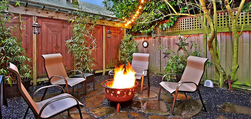 Stunning Patio with Rustic Fire Pit and String Lights